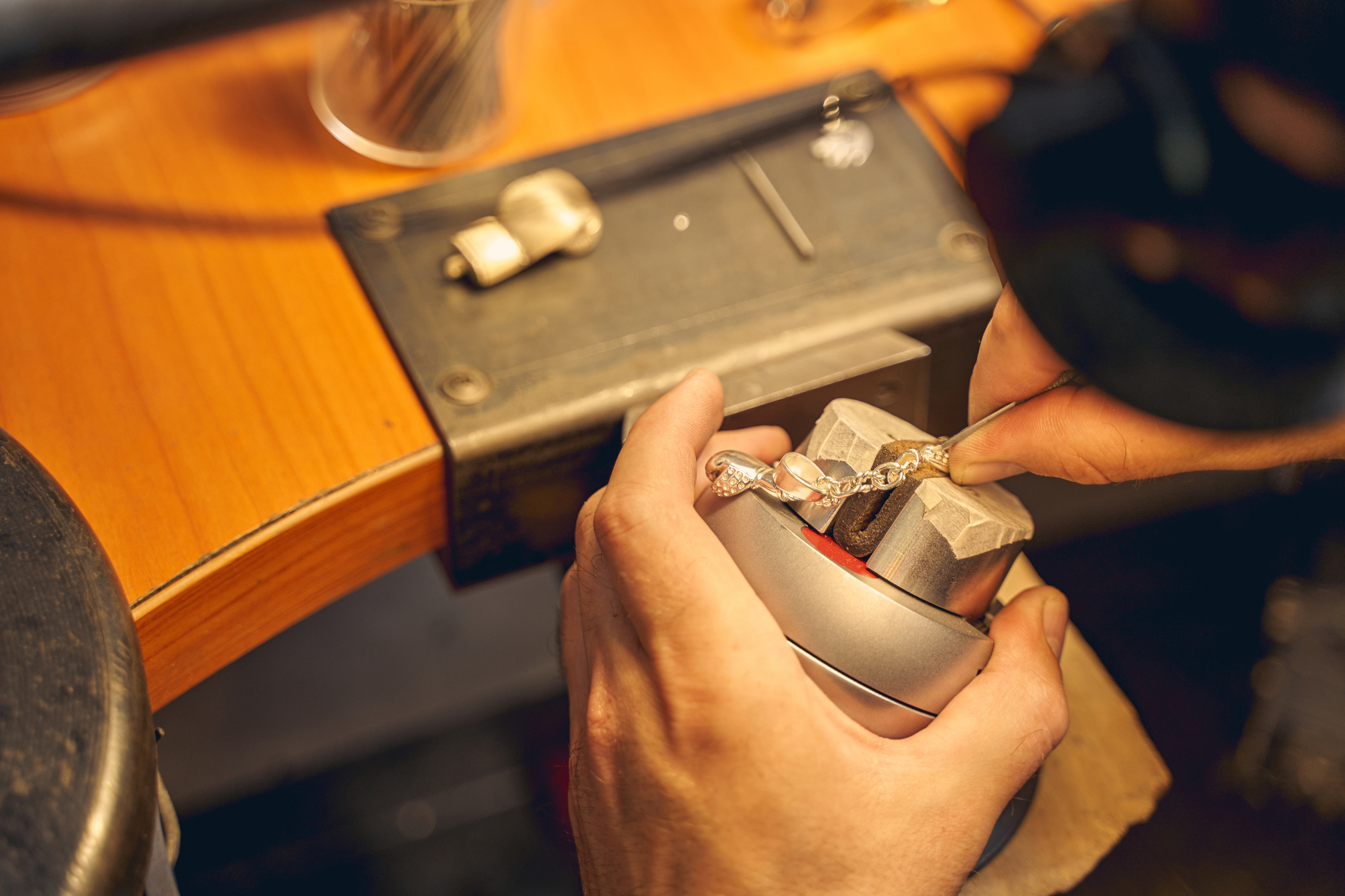 Skilled craftsman treating a new jewelry item
