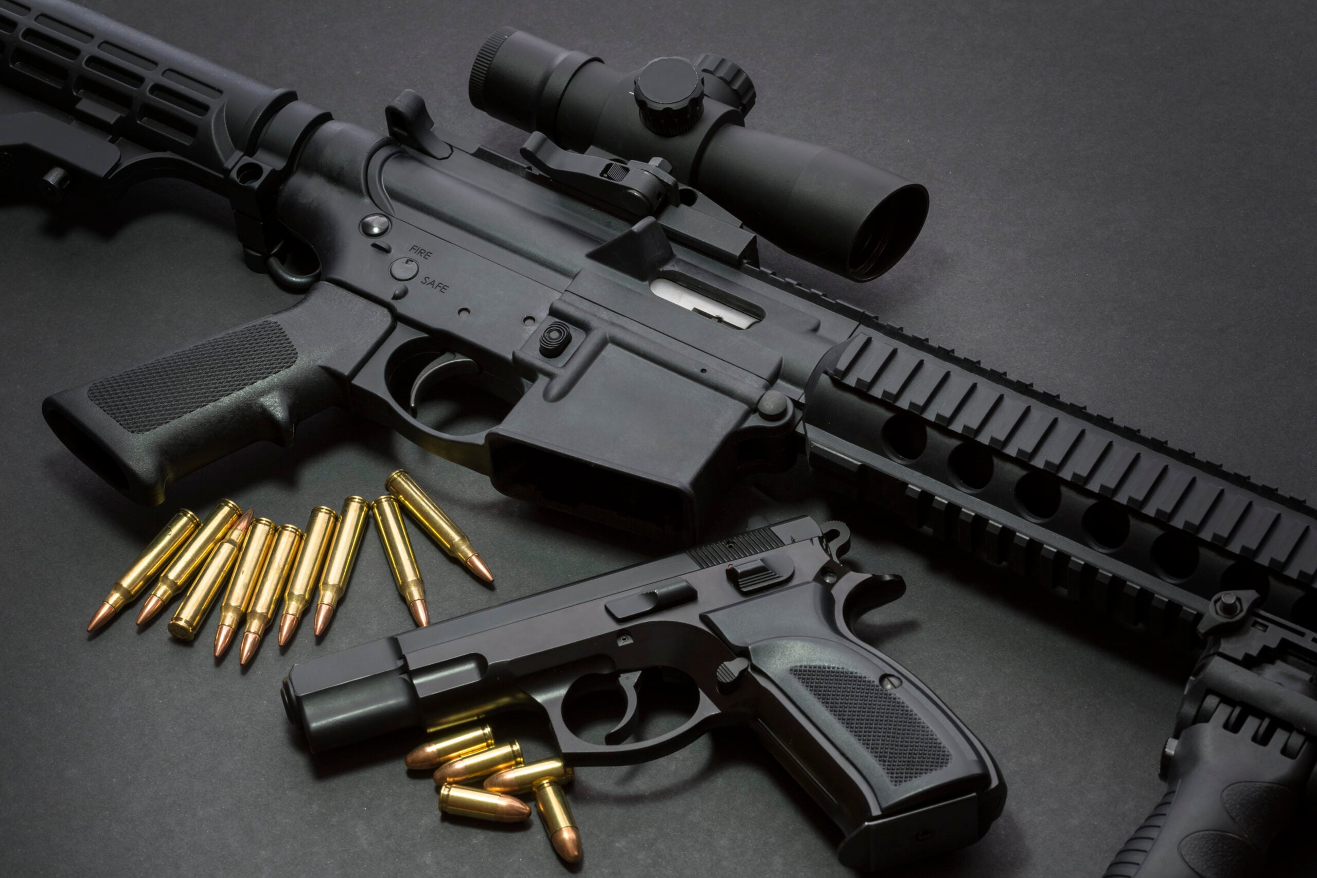black-guns-and-ammunition-on-dark-surface-2026-03-18-04-31-21-utc
